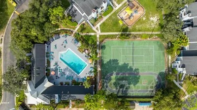 an overhead view of a tennis court and a pool at Modern 2BR Stay in Prime Location in Orlando