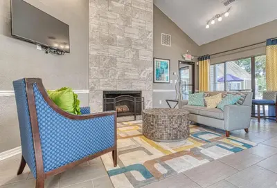 a living room with a couch and a fireplace at Modern 2BR Stay in Prime Location in Orlando
