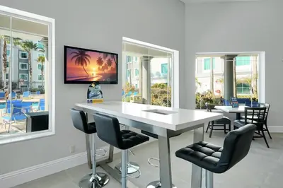 a dining room with a white table and chairs at Free Shuttle Mickey Universal Epic SeaWorld in Orlando