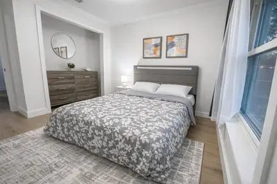 a bedroom with a bed and a dresser and a window at Family Retreat - 9 Min from Disney in Kissimmee