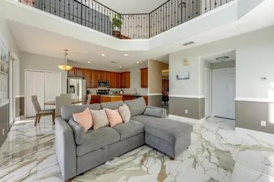 a living room with a couch and a kitchen at Fish and Boat Lake Toho Family Gem Near Theme Parks in Kissimmee