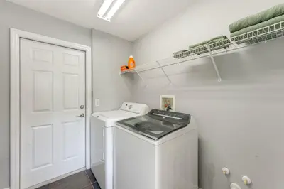 a white laundry room with a washer and dryer at Fish and Boat Lake Toho Family Gem Near Theme Parks in Kissimmee