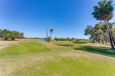 a view of a golf course with palm trees at Fish and Boat Lake Toho Family Gem Near Theme Parks in Kissimmee