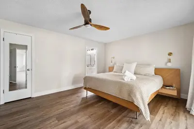a bedroom with a bed and a ceiling fan at Spacious home w screened patio & EV charger in Orlando