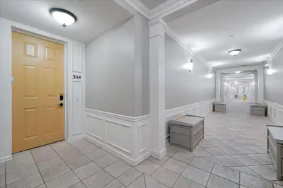 a room with a yellow door and a tile floor at Epic Universe Condo - Vista Cay - 2028 in Orlando