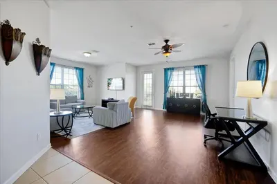 a living room with a couch and a table at Epic Universe Condo - Vista Cay - 2028 in Orlando
