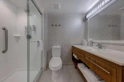 a bathroom with a toilet and a shower and a sink at Home2 Suites by Hilton Orlando International Drive South - Free Shuttle to Theme Parks in Orlando