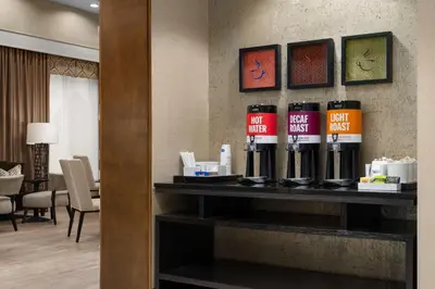 a shelf in a hotel room with bottles on it at Hampton Inn & Suites Orlando/Downtown South - Medical Center in Orlando