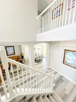 a white staircase in a home with a living room at Clermont Vacation Homes by DWS Vacation in Orlando