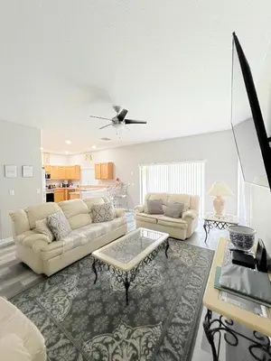 a living room with two couches and a table at Clermont Vacation Homes by DWS Vacation in Orlando