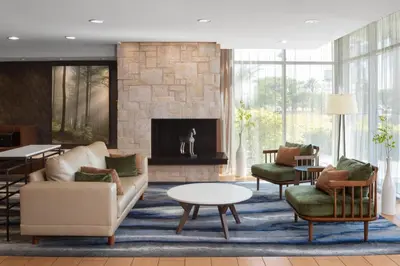 a living room with furniture and a fireplace at Fairfield Inn & Suites by Marriott Orlando Kissimmee/Celebration in Orlando