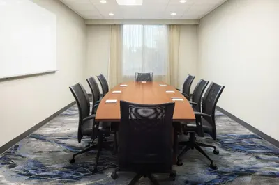 a conference room with a wooden table and chairs at Fairfield Inn & Suites by Marriott Orlando Kissimmee/Celebration in Orlando