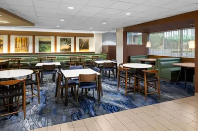 a dining room with tables and chairs at Fairfield Inn & Suites by Marriott Orlando Kissimmee/Celebration in Orlando