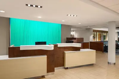 an office lobby with a green wall and desks at Fairfield Inn & Suites by Marriott Orlando Kissimmee/Celebration in Orlando