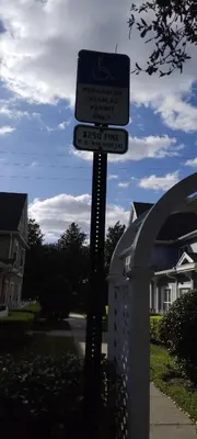 a street sign on a pole in front of a house at True Happiness, Housing Near Disney Word in Kissimmee