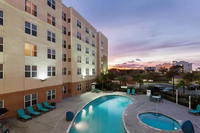 a view of a pool in front of a building at Residence Inn Orlando Airport in Orlando
