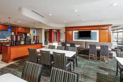 a conference room with a table and chairs at Residence Inn Orlando Airport in Orlando