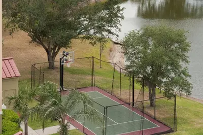 an aerial view of a tennis court next to a lake at Residence Inn Orlando Airport in Orlando