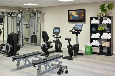 a gym with several treadmills and exercise bikes at Renaissance Orlando Airport Hotel in Orlando
