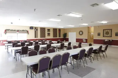 a room with rows of tables and chairs at Sherwood Forest Cottage 6 in Kissimmee