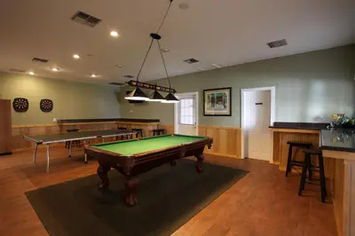 a large room with a pool table and a bar at Sherwood Forest Cottage 6 in Kissimmee