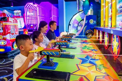a group of people playing a video game in a arcade at The Grove Resort & Water Park Orlando in Orlando