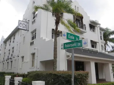 a street sign in front of a building with a palm tree at The EO Inn - Downtown Orlando in Orlando