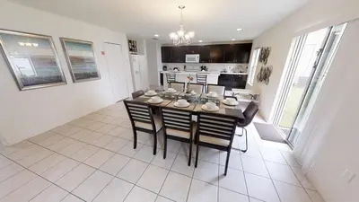 a kitchen and dining room with a table and chairs at Crystal Cove 4 Bedroom Vacation Home 1527 in Kissimmee