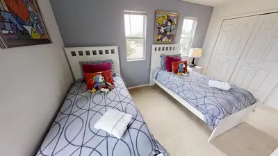two twin beds in a room with two windows at Crystal Cove 4 Bedroom Vacation Home 1527 in Kissimmee
