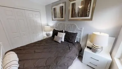 a bedroom with a large bed with two lamps and a bed sidx sidx sidx sidx at Crystal Cove 4 Bedroom Vacation Home 1527 in Kissimmee