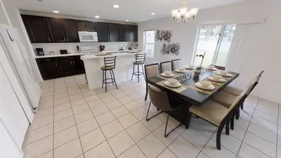 a kitchen and dining room with a table and chairs at Crystal Cove 4 Bedroom Vacation Home 1527 in Kissimmee