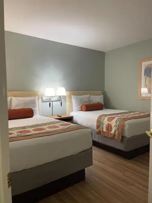 a hotel room with two beds and two lamps at Star Island Resort and Club - Near Disney in Kissimmee