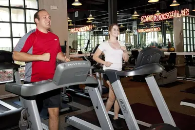 a man and a woman riding on treadles in a gym at Star Island Resort and Club - Near Disney in Kissimmee