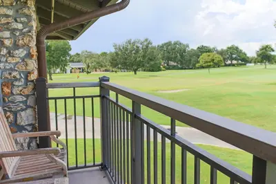 a balcony with a view of a golf course at Arnold Palmer's Bay Hill Club & Lodge in Orlando