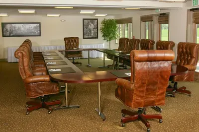 a conference room with a table and leather chairs at Arnold Palmer's Bay Hill Club & Lodge in Orlando