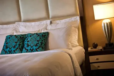a bedroom with a bed with a blue pillow on it at Renaissance Orlando at SeaWorld® in Orlando
