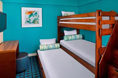 two bunk beds in a room with blue walls at Fairfield Inn & Suites by Marriott Orlando Lake Buena Vista in the Marriott Village in Orlando