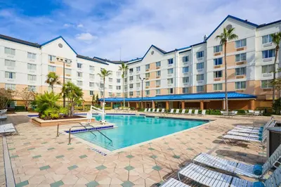an image of a hotel with a swimming pool at Fairfield Inn & Suites by Marriott Orlando Lake Buena Vista in the Marriott Village in Orlando