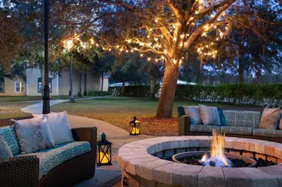 a fire pit in a yard with couches and lights at Residence Inn by Marriott Orlando at SeaWorld in Orlando