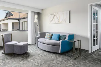 a living room with a couch and a chair at Courtyard by Marriott Orlando Lake Buena Vista at Vista Centre in Orlando