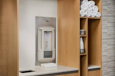 a drink dispenser in a room with a shelf at Courtyard by Marriott Orlando Lake Buena Vista at Vista Centre in Orlando