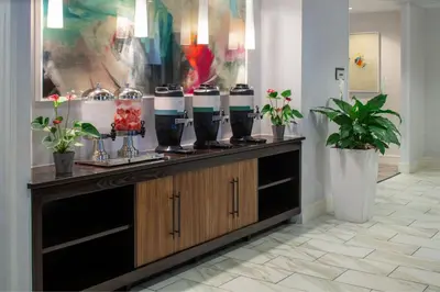 a room with a counter with a group of coffee machines at SpringHill Suites by Marriott Orlando Convention Center in Orlando
