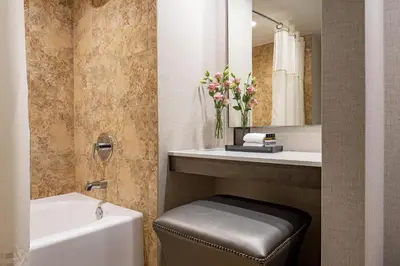 a bathroom with a sink and a tub and a toilet at Hyatt Regency Orlando International Airport Hotel in Orlando