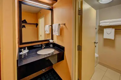 a bathroom with a sink and a mirror at Fairfield Inn and Suites by Marriott Orlando Near Universal Orlando in Orlando