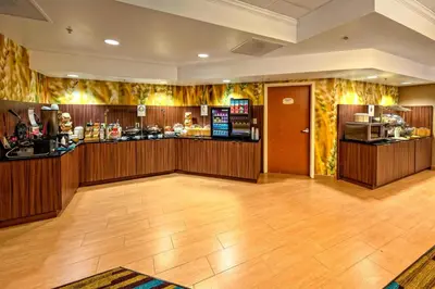 a restaurant with a bar in a room at Fairfield Inn and Suites by Marriott Orlando Near Universal Orlando in Orlando