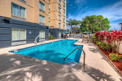 a swimming pool in front of a building at Fairfield Inn and Suites by Marriott Orlando Near Universal Orlando in Orlando