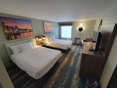 a hotel room with two beds and a flat screen tv at La Quinta Inn by Wyndham Orlando International Drive North in Orlando