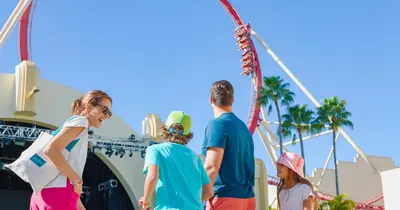 a group of people standing in front of a ferris wheel at Hotel Landy Orlando Universal Blvd, a Tribute Portfolio Hotel in Orlando