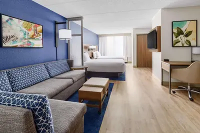 a hotel room with a couch and a bed at Hyatt Place across from Universal Orlando Resort in Orlando