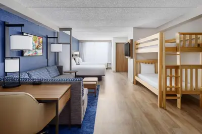 a hotel room with a bunk bed and a bedroom at Hyatt Place across from Universal Orlando Resort in Orlando